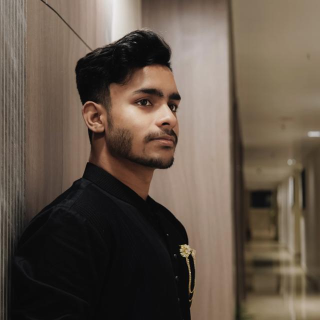 Portrait of Abhimanyu Sharma in a black jacket, looking to the right.